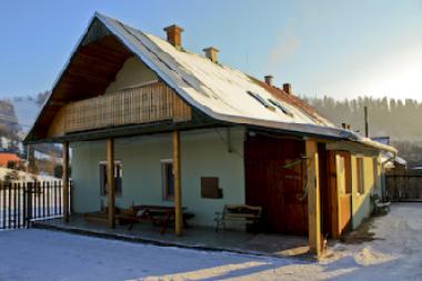 Front view of the house with the ski slope in the background.