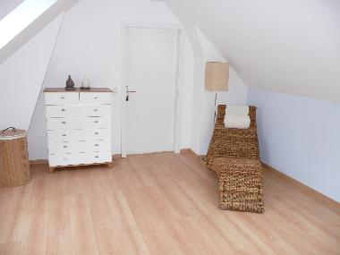 Im Schlafzimmer mit Doppelbett befindlicher Relaxstuhl