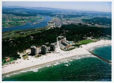 On one side, the extensive ocean with a beach of golden sand.