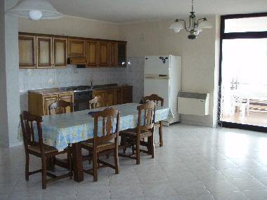 geraeumige Wohnkueche des Ferienhauses - im Hintergrund: Fenster zum Wintergarten mit zweiter Kueche