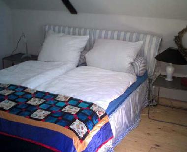 Im Schlafzimmermit  Doppelbett und Fernseher