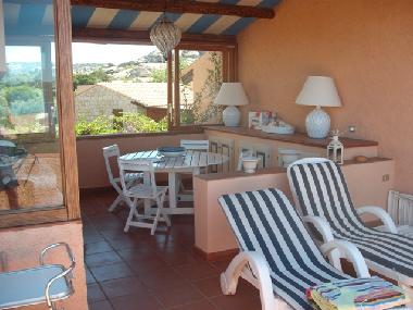 Blick auf die teilberdachte Veranda Tisch und Sonnenliegen