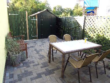 gepflasterte und sichtgesch�tzte Sitz-/Grillecke f�r sechs Personen am Haus 