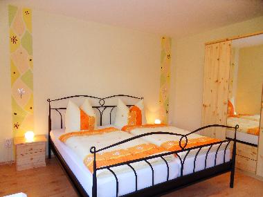 Schlafzimmer mit Doppelbett und Doppelstockbett