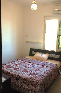sleeoing room with double bed, wardrobe, aircondition