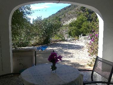 Blick aus dem Wohnzimmerfenster auf die Terrasse mit Sitzecke