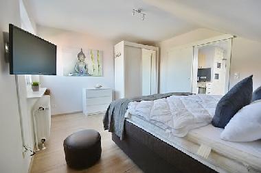 Schlafsimmer mit Schrank, Kommode und TV