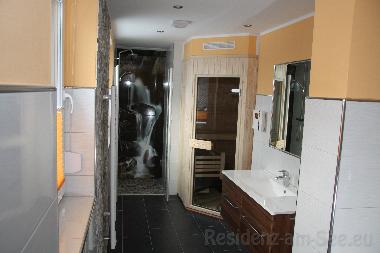 Badezimmer mit Saune und Badewann im Obergeschoss