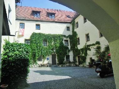 kommen Sie durch den Torbogen in den Schlossinnenhof mit Parkpltzen